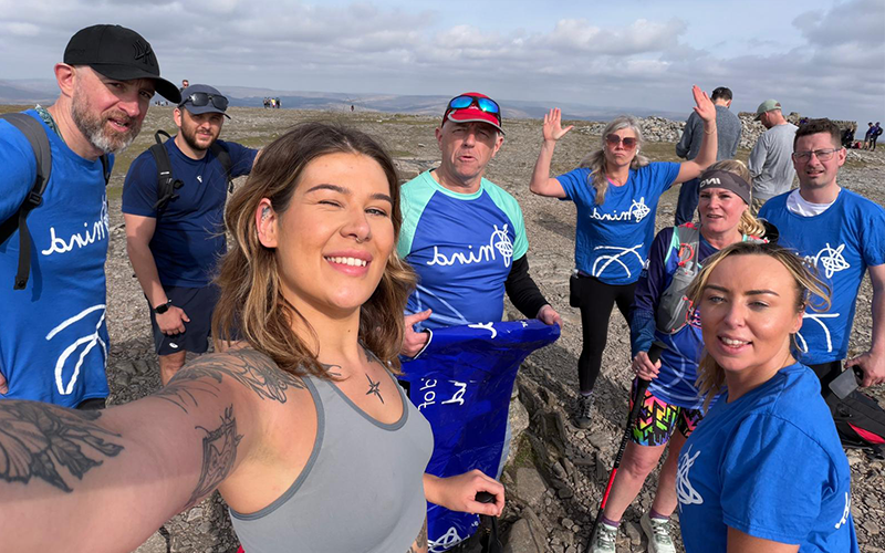 A smiling group selfie of the Major Recruitment team while walking the Yorkshire Three Peaks Challenge in support of MIND charity
